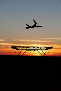 silhouette of trampoline gymnast in sunset